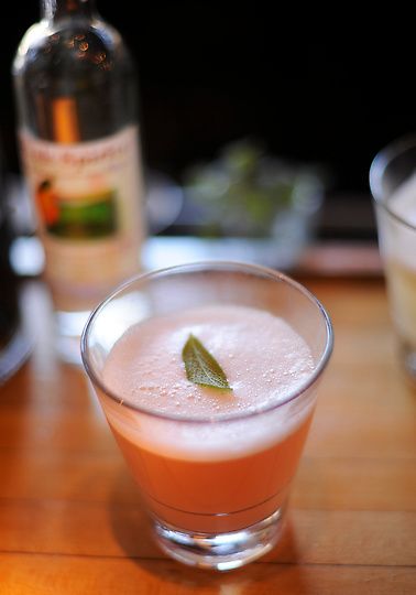 1 ноября опытный бармен высокого класса Аника Запп мешает коктейли в одном из ресторанов Денвера, br в состав которых входит натуральное персиковое бренди ручной работы «Eau de Vie». Бармен украсил напиток листиком шалфея.